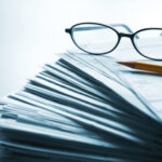 Glasses on a stack of papers