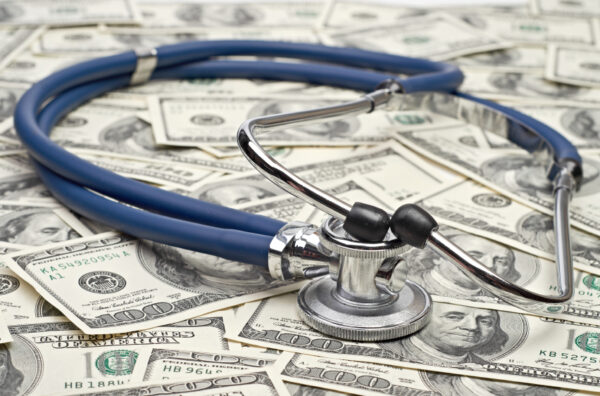 heap of dollars with stethoscope